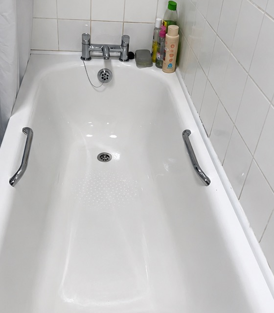 The same bath after a Beravo deep clean, bright white